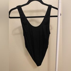 Black bodysuit with low back. Never worn.